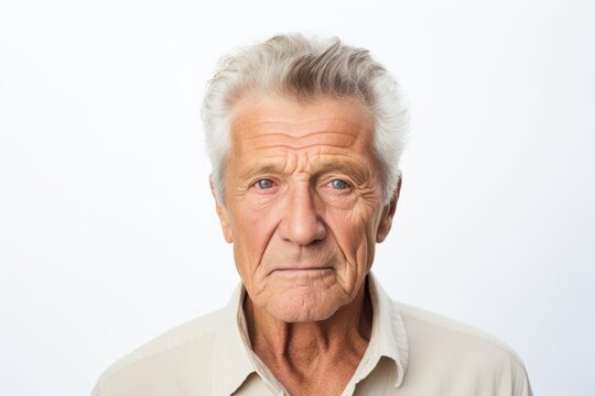Portrait of a senior man looking at the camera on white background