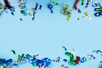 Confetti on blue background, sparkles of celebration, festive fair atmosphere