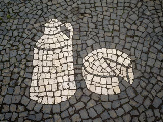 Foto op Canvas Black and white sidewalk stone pavement with a representation of a milk container and cheese © Sérgio Nogueira