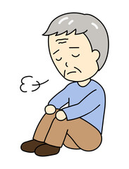 体育座りでため息をつくうつ病のおじいさん