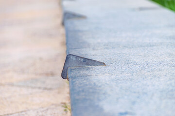 Anti-skateboarding devices on a stone fence. Anti roller spike