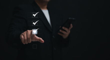 Businessman uses mobile for online assessments and surveys. Showcases digital checklists and...