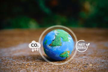 Explore a small world globe symbolizing CO2 reduction and net zero emissions by 2050. Embrace the...