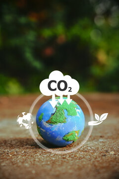 Explore a small world globe symbolizing CO2 reduction and net zero emissions by 2050. Embrace the icon of sustainability and join the journey towards a greener future.