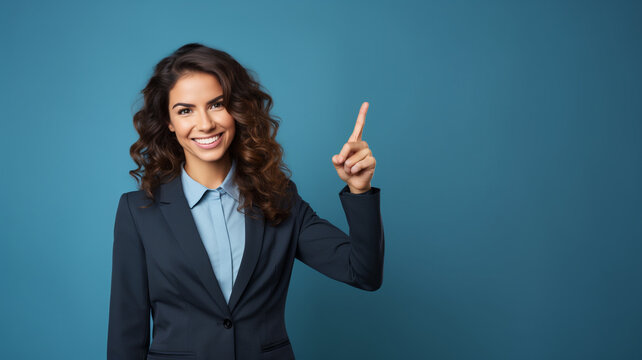 Smiling business woman pointing up and looking at camera