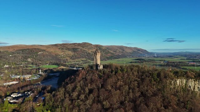 Drone footage of the National Wallace Monument on a sunny day in Stirling, Scotland, UK