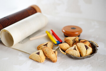 Scroll of Esther and haman's ears cookies. Jewish holiday Purim.