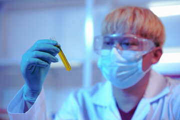 Asian middle-aged male scientist conducts research in a laboratory, surrounded by petri dishes and...