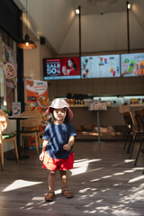 Little beautiful 3 year kindergarten girl enjoying relax in coffee shop
