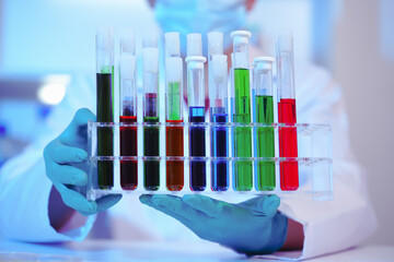 Asian middle-aged male scientist conducts research in a laboratory, surrounded by petri dishes and beakers. Investigate the chemistry of gasoline, food ingredients, perfumes, viruses, and medicine