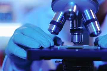 Asian middle-aged male scientist conducts research in a laboratory, surrounded by petri dishes and beakers. Investigate the chemistry of gasoline, food ingredients, perfumes, viruses, and medicine