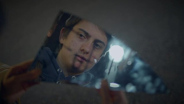 Young Lost Man with Suitcase Finding Broken Mirror on Urban Street at Night