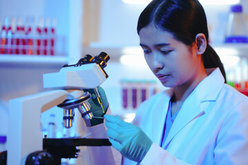 Asian female scientist passionately conducts experiments in a laboratory, surrounded by petri...