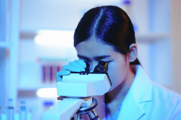 Asian female scientist passionately conducts experiments in a laboratory, surrounded by petri...