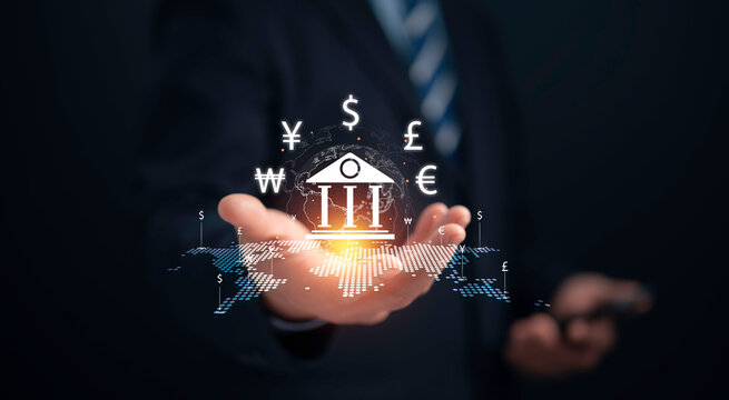 Businessman hold virtual central banking and international currency include dollar Yuan Yen Pound sterling and Euro for forex and currency exchange money transfer concept.Business finance. - Powered by Adobe