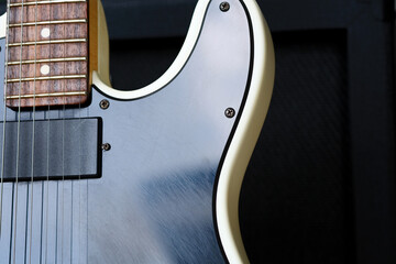 Electric guitar on the background of the guitar amplifier. Close-up.