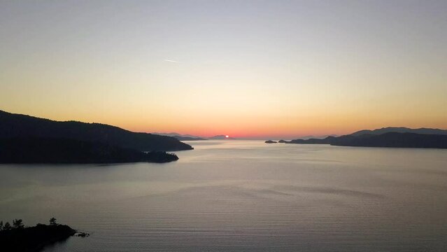 Capturing Sunset's Majesty: Breathtaking Vertical Drone Video as Sun Dips Below Horizon