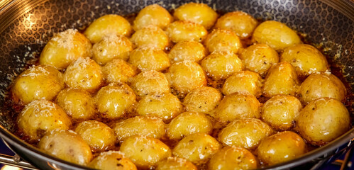 Roasted potato in frying pan. Homemade cooking fresh baked potato, serving food for restaurant, menu, advert or package, close up, selective focus