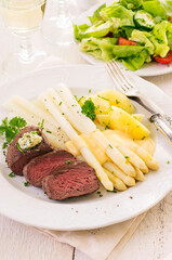 Traditional roasted angus beef steak with with white asparagus, boild potatoes and fresh salad...