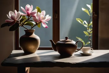 Fototapeten Minimalist interior with live edge concrete countertop. Ceramic vase with magnolia branch and ceramic teapot. Ceramist's workshop. Sunlight and long shadows. Interior elements © svetlana_nsk