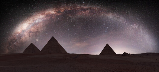 The Milky Way rises over the Pyramids in Giza, Egypt - obrazy, fototapety, plakaty