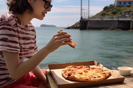 A Woman Enjoying A Pizza Snack Outdoors