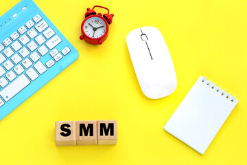 Wooden cubes with word smm..Alarm clock, keyboard, mouse.