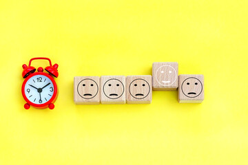 alarm clock,  cubes with person icons on the background.