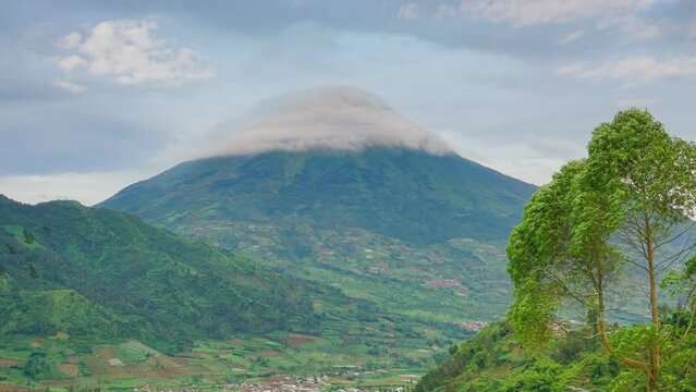 Sindoro mountain of Dieng with moving clouds. Time lapse looping moving clouds, 4k video background 