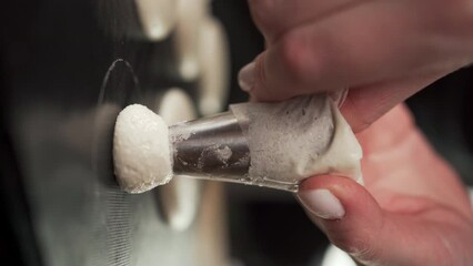 Chef pastry holding piping bag, squeezing macaron batter onto white parchment paper on sheet pan in circles. French macarons baking. - Powered by Adobe