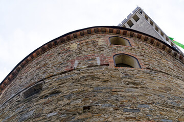 Looking up stone wall and tower with loophole of Castle of Ljubljana on a cloudy summer day. Photo...