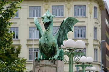 Close-up of green bronze dragon sculpture at famous Dragon Bridge City of Ljubljana on a cloudy...