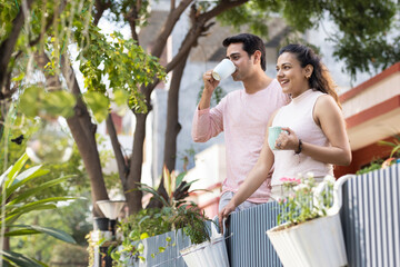 Couple spending leisure time together while drinking coffee outdoors