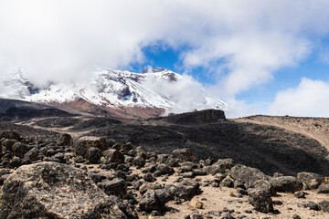 Ascending Majesty: A Glimpse of Kilimanjaro’s Peak and Lava Rocks