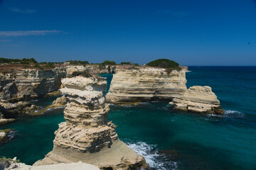Rock stacks and crystal clear sea at Torre di Sant'Andrea, Melendugno, Lecce province, Italy