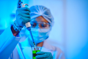 Female scientist diligently conducts virus blood lab tests, contributing to critical research and...