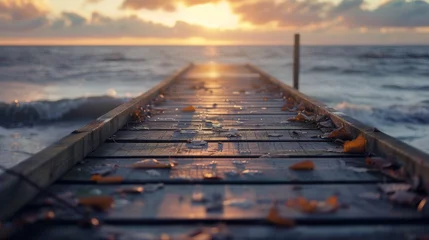 Deurstickers Afdaling naar het strand As the sun sets over the horizon, a peaceful wooden dock extends into the glistening ocean, its boardwalk inviting us to take a stroll and soak in the serene seascape