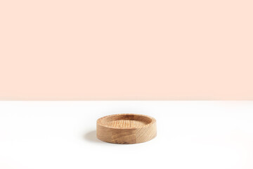 Podium for cosmetic product presentation. Abstract minimal geometrical form on white background. One wooden form, shadow. Scene, Showcase, display. Minimal design. Trendy sunlight. Front View