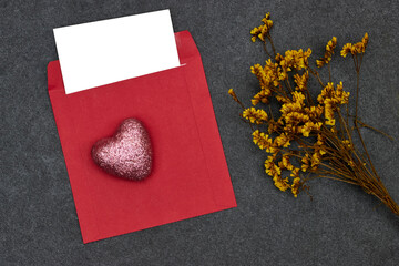 Wedding invitation card mockup and red envelope with pink heart toy glitter, yellow gypsophila. Blank card mockup