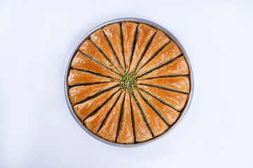 Top view of carrot slice baklava on a tray isolated on white background.
