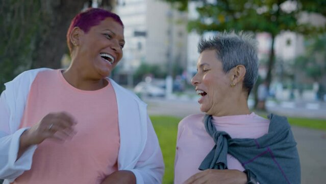 Senior lesbian couple with high five for workout, running and exercise outdoor with happiness. Elderly, people and training with smile for performance, teamwork and motivation in nature
