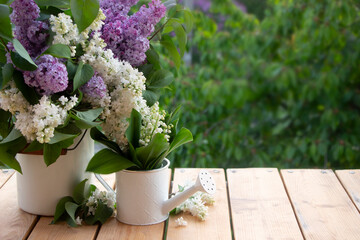 Spring lilac bouquet on wooden board, green leaves on background. Women's Day, Mother's Day, 8...