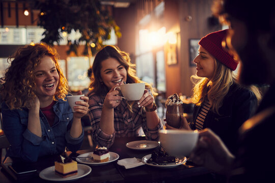 Young people enjoying coffee together at an indoor cafe