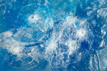 Blue ice surface with cracks background texture. close-up frozen water. broken ice.