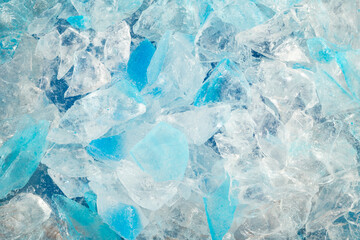 broken ice close up. pieces of crushed blue ice cracks background texture. close-up frozen water.