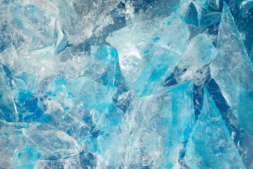 broken ice close up. pieces of crushed blue ice cracks background texture. close-up frozen water.