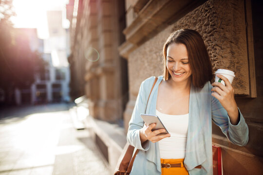 Young adult woman using a smart phone in the city