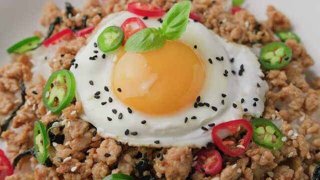 Pad Krapow Gai, Thai Basil Chicken with rice and fried egg. Rotating video