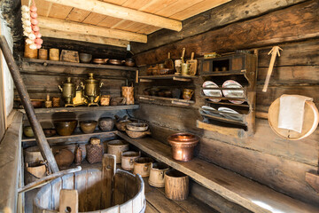 The interior of one of the rooms for storing dishes of a peasant of the Russian north. The Museum of Wooden Architecture of Maly Korely. Arkhangelsk region, Russia - 738801471