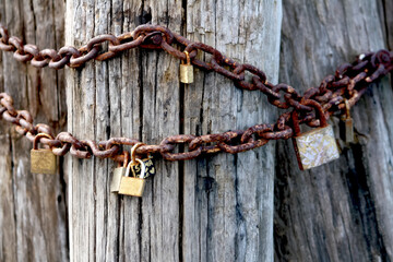 Rusty love locks on an old pole, a romantic gesture of undying love